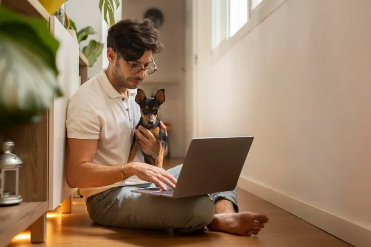 Remote employee working from his home with his dog