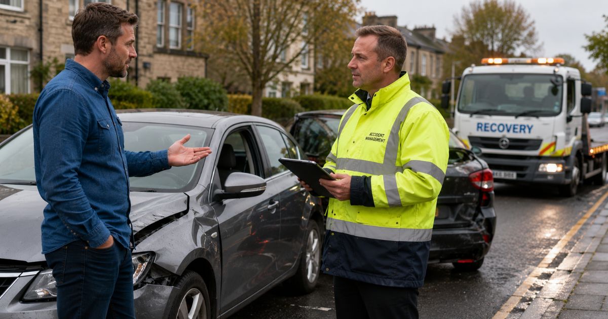 UK driver speaking with an accident management representative after a car accident while arranging a courtesy car